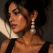 Woman wearing elegant earrings with a neutral background